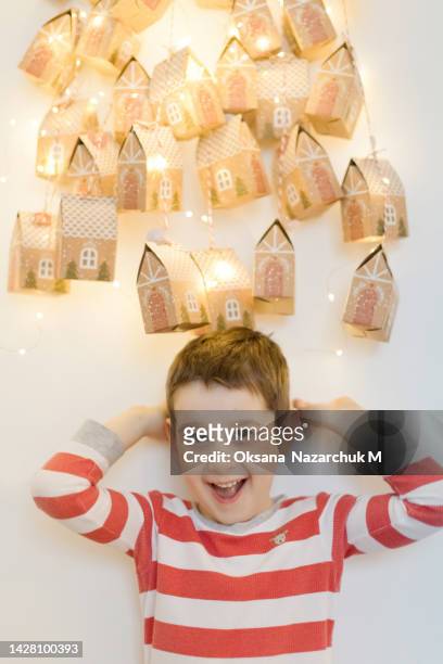 caucasian boy and advent calendar - child with advent calendar stock pictures, royalty-free photos & images