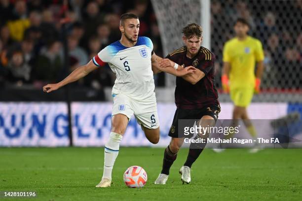 Taylor Harwood-Bellis of England is challenged by Jan Thielmann of Germany during the International Friendly match between England U21 and Germany...