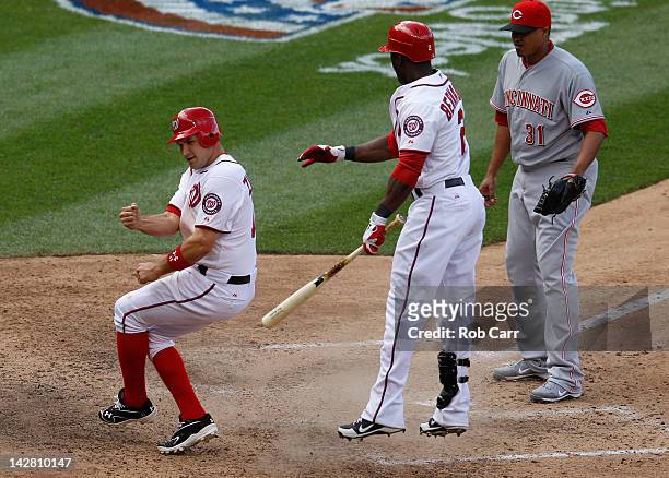 Batter Roger Bernadina of the Washington Nationals looks on as Ryan Zimmerman celeberates after scoring the game winning run on a wild pitch by...