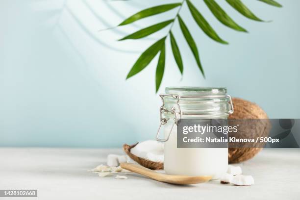 coconut oil in jar with fresh coconut - shavuot stock pictures, royalty-free photos & images
