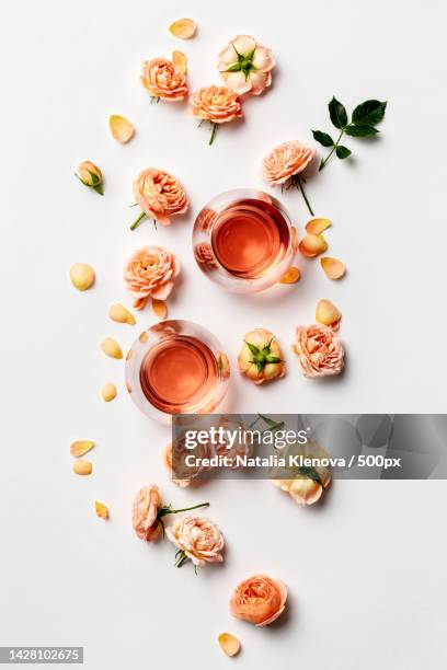 rose wine and roses on white background - pink drink stock pictures, royalty-free photos & images