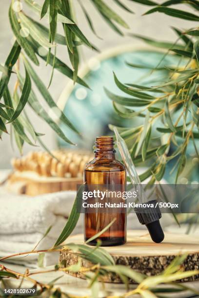 close-up of essential oil on table - aromatherapy oil stockfoto's en -beelden