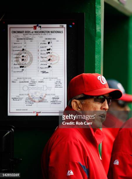 Manager Davey Johnson looks on from the dugout during the fifth inning of their opening day game against the Cincinnati Reds at Nationals Park on...