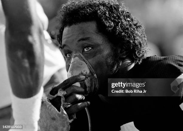 Raiders CB Lester Hayes inhales oxygen during break in game action of Los Angeles Raiders against Miami Dolphins, August 19, 1984 in Los Angeles,...