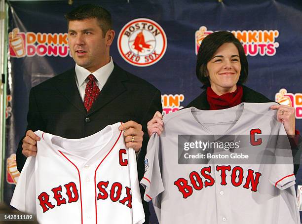 At Fenway Park, Red Sox catcher Jason Varitek holds his game jerseys with his wife, Karen, as he was given the designation as team captain, at a...