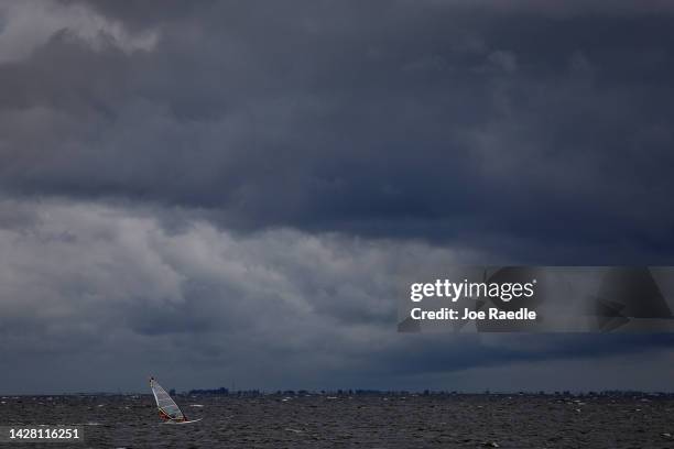 Windsurfer cruises through the water as clouds from the approaching Hurricane Ian darken the sky on September 27, 2022 in St Petersburg, Florida....