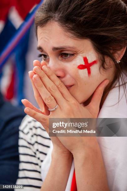 trauriger junger englischer fußballfan mit england-flagge um den hals, der während des nationalmannschaftsspiels weint - england fans stock-fotos und bilder