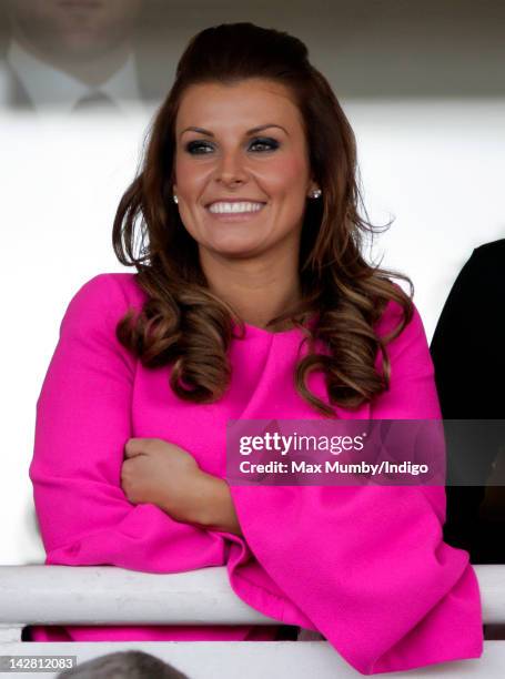 Coleen Rooney watches the races as she attends 'Liverpool Day' of the John Smith's Grand National horse racing meeting at Aintree Racecourse on April...