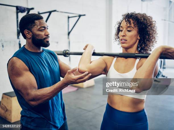 trainer working with a woman in a gym - personlig tränare bildbanksfoton och bilder