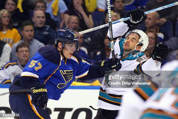 David Perron of the St. Louis Blues pushes Dan Boyle of the San Jose Sharks out of his way during Game One of the Western Conference Quarterfinals...