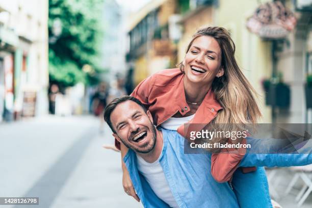 portrait of happy young couple outdoors - cute girlfriends stock pictures, royalty-free photos & images