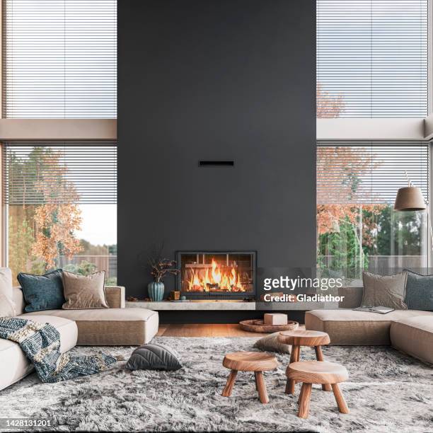 cozy, luxury and modern living room with large windows, sofa, chairs, decoration and fireplace - grey sofa stock pictures, royalty-free photos & images