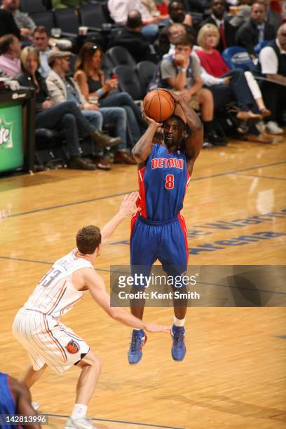Ben Gordon of the Detroit Pistons shoots against Matt Carroll of the Charlotte Bobcats at the Time Warner Cable Arena on April 12, 2012 in Charlotte,...