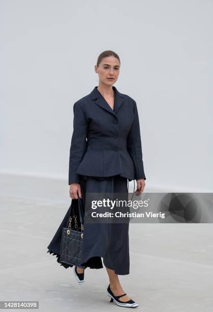 Sophia Roe wears black tailored jacket, skirt, black bag, black white heels outside Dior during Paris Fashion Week - Womenswear Spring/Summer 2023 :...