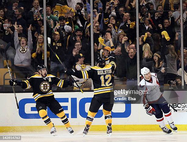 Chris Kelly of the Boston Bruins celebrates his game winning goal in overtime with Brian Rolston as Dennis Wideman of the Washington Capitals skates...