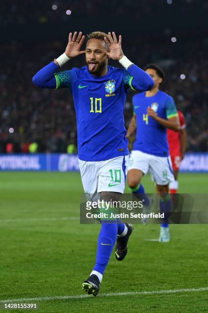 Neymar of Brazil celebrates after scoring their sides third goal from the penalty spot during the International Friendly match between Brazil and...