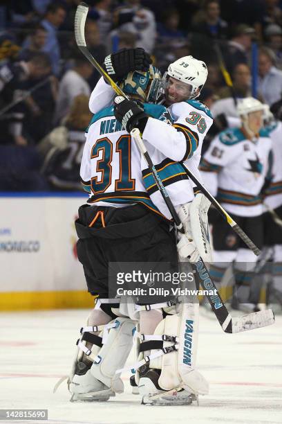 Antti Niemi and Logan Couture of the San Jose Sharks celebrate the Sharks' double-overtime game-winning goal against the St. Louis Blues during Game...