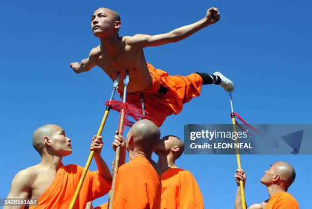 Shaolin Wu-Shu Warriors balance one of the performers on spears as the Chinese State Circus arrives at Alexandra Palace in north London, on April 8,...