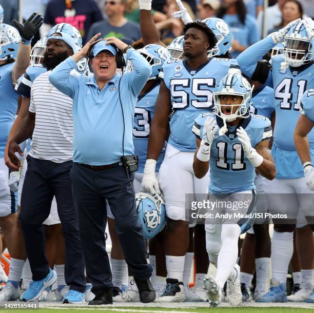Head coach Mack Brown and Josh Downs of the University North Carolina react as their team is called for a penalty while defending a fourth and goal...