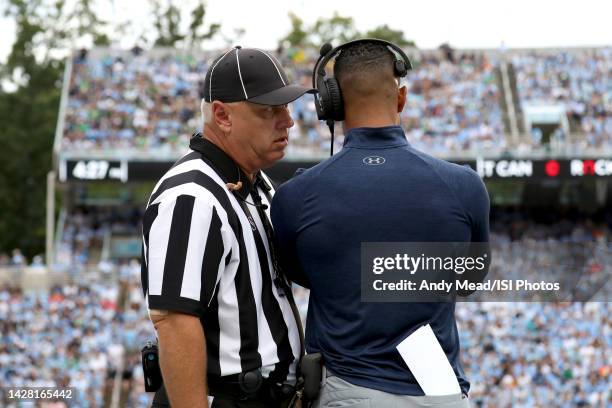 Line Judge Kirk Lewis talks to head coach Marcus Freeman of the University Notre Dame during a game between Notre Dame and North Carolina at Kenan...