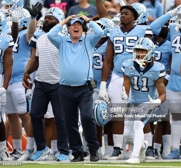 Head coach Mack Brown and Josh Downs of the University North Carolina react as their team is called for a penalty while defending a fourth and goal...