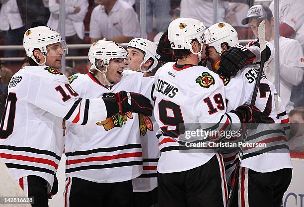 Brent Seabrook of the Chicago Blackhawks celebrates with Patrick Sharp, Patrick Kane and Jonathan Toews after Seabrook scored the game tying goal...