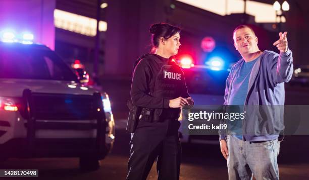 policewoman questioning suspect or witness - witness stock pictures, royalty-free photos & images