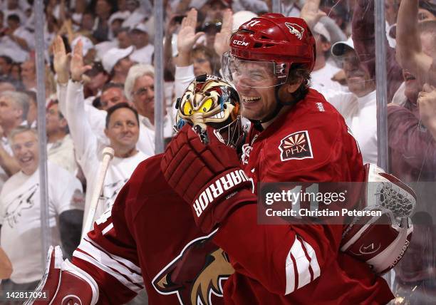 Martin Hanzal of the Phoenix Coyotes celebrates with goaltender Mike Smith after Hanzal scored the game winning goal in overtime of Game One of the...