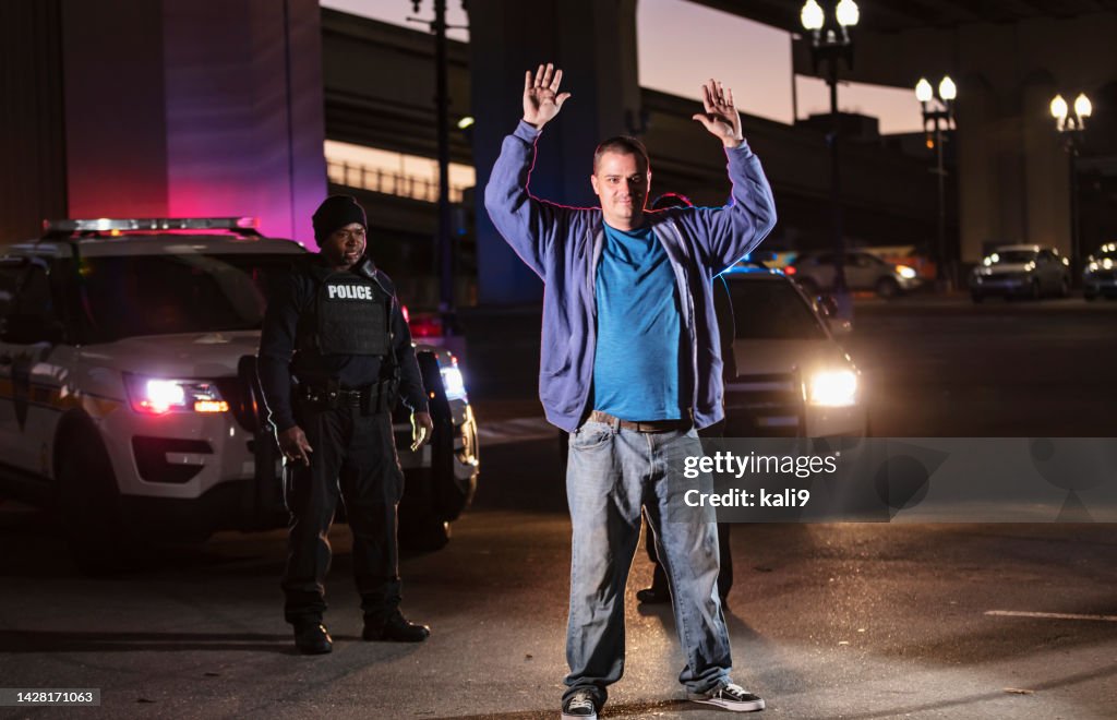 A Surrender Suspect Surrendering To Police Officer At Night High-Res Stock Photo ...