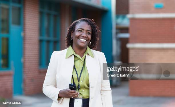 african-american teacher or principal outside school - administrador stock pictures, royalty-free photos & images