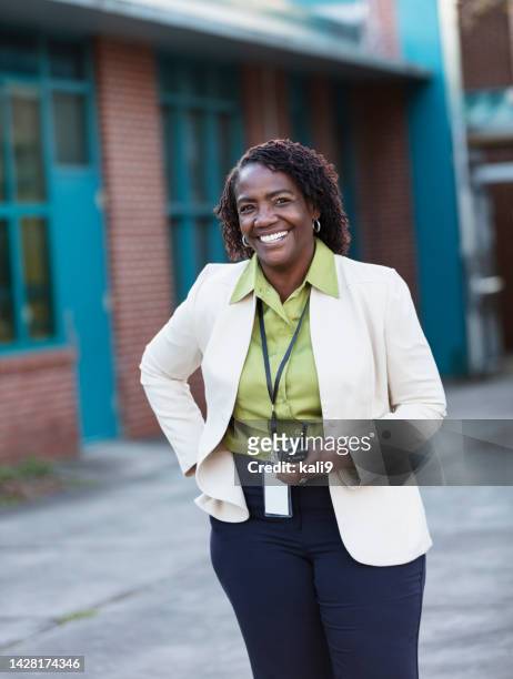 african-american teacher or principal outside school - school principal stock pictures, royalty-free photos & images