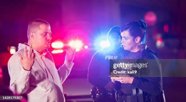 police officers taking statement from witness or victim - getuige stockfoto's en -beelden