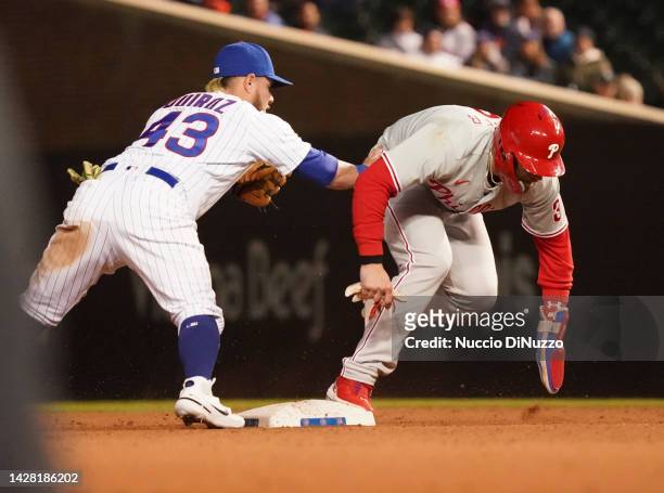 Bryce Harper of the Philadelphia Phillies is tagged out by Esteban Quiroz of the Chicago Cubs during a force out in the ninth inning at Wrigley Field...