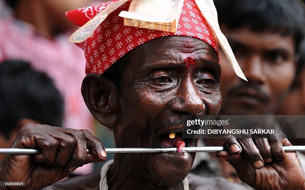 An Indian Hindu devotee adjusts a metal