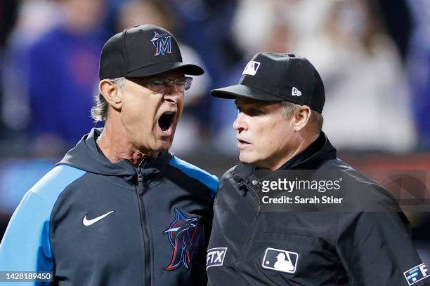 Manager Don Mattingly of the Miami Marlins reacts toward umpire Marvin Hudson after a call during the eighth inning against the New York Mets at Citi...
