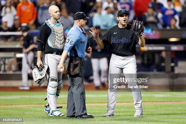 Jacob Stallings looks on as Richard Bleier of the Miami Marlins reacts toward a call by umpire Ryan Blakney during the eighth inning against the New...