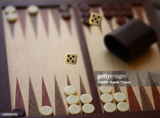 dice in action- backgammon - backgammon stock pictures, royalty-free photos & images