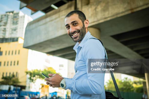 lebanese man using cellphone in the street - lebanese ethnicity stock pictures, royalty-free photos & images