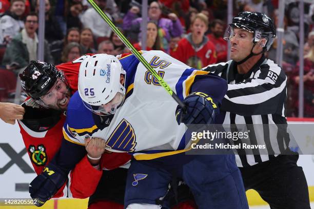 Colin Blackwell of the Chicago Blackhawks and Jordan Kyrou of the St. Louis Blues fight during the third period of a preseason game at United Center...