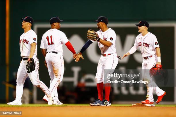 Xander Bogaerts of the Boston Red Sox celebrates with teammate Rafael Devers after the victory over the Baltimore Orioles at Fenway Park on September...