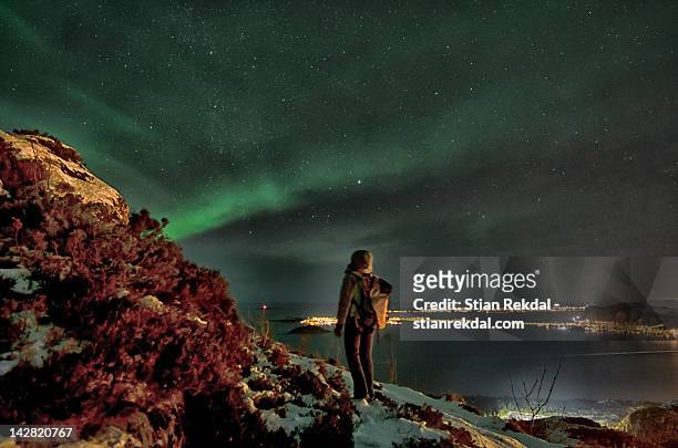 person watching aurora borealis in sky - alesund noorwegen stock pictures, royalty-free photos & images