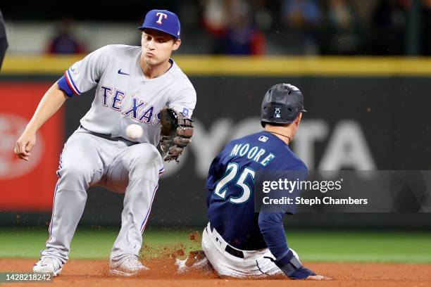 Dylan Moore of the Seattle Mariners steals second base past Corey Seager of the Texas Rangers during the seventh inning at T-Mobile Park on September...