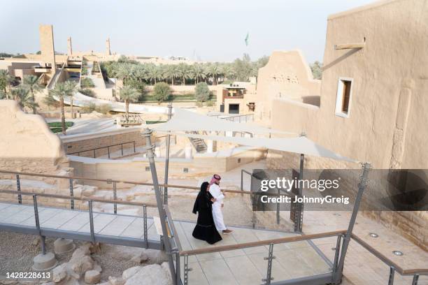 local couple in traditional attire visiting diriyah ruins - saudi people stock pictures, royalty-free photos & images