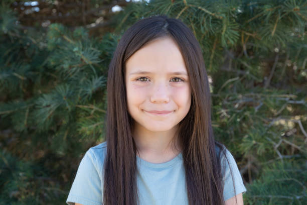 young hispanic girl looking at camera and smiling - madeline ohare stock pictures, royalty-free photos & images