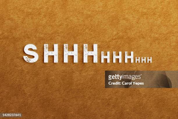 shhhh message in paper work.brown background - shhhh stock-fotos und bilder