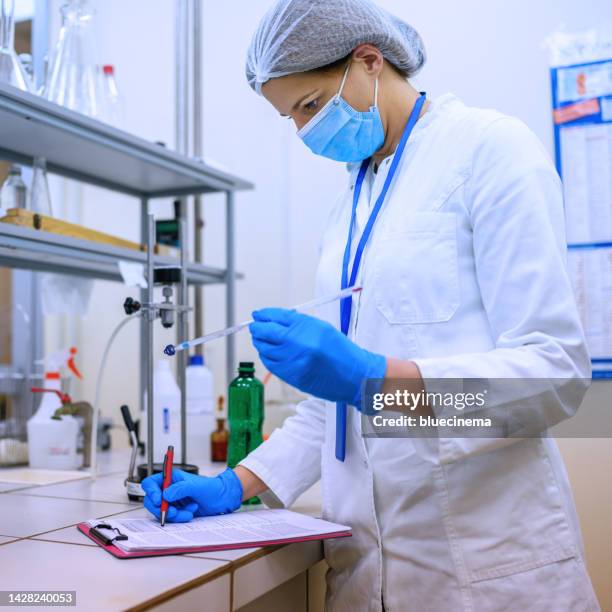 scientist analyzing sample in the laboratory - solutions chemistry stock pictures, royalty-free photos & images