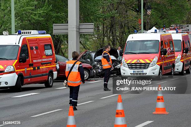 Rescuers and firefighters work around wrecked cars on April 13, 2012 in Chambery, central eastern France, after an accident involving six vehicles,...