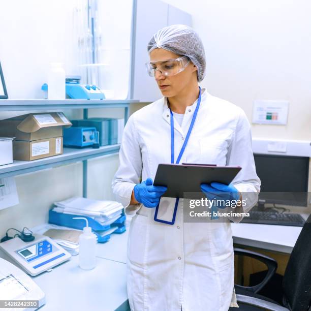 scientist analyzing sample in the laboratory - bottling plant stock pictures, royalty-free photos & images