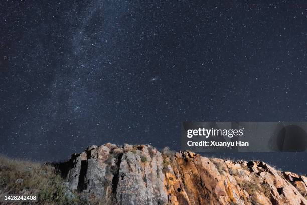 starry sky and mountain landscape at night - rocky star stock pictures, royalty-free photos & images