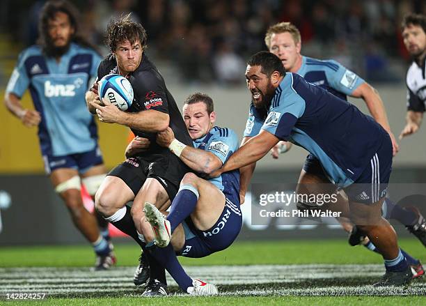 Craig Burden of the Sharks is tackled by Alby Mathewson of the Blues during the round eight Super Rugby match between the Blues and the Sharks at...